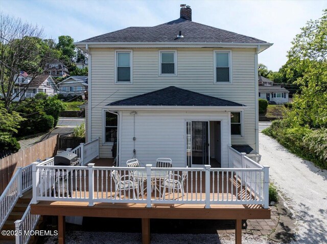 78 Navesink Ave, Highlands, NJ 07732 - rear view of property featuring a chimney, a deck, a shingled roof, and fence