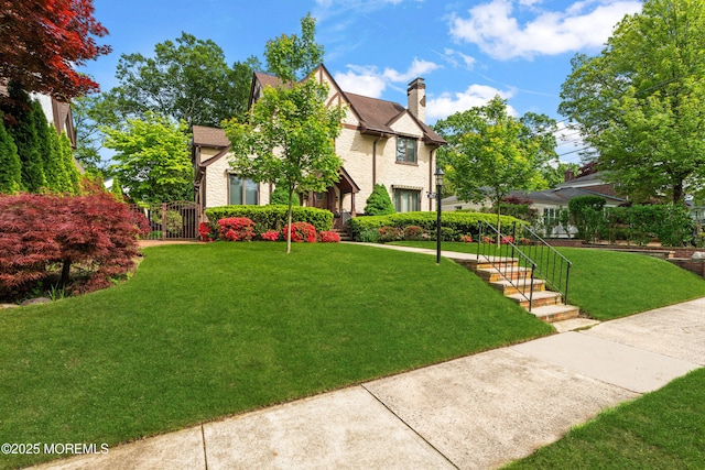 567 Deal Pkwy, Allenhurst, NJ 07711 - tudor home featuring a front yard and a chimney