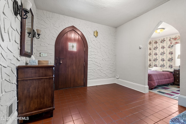 567 Deal Pkwy, Allenhurst, NJ 07711 - tiled foyer featuring arched walkways and a textured ceiling
