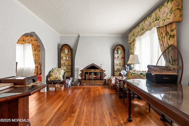 567 Deal Pkwy, Allenhurst, NJ 07711 - living area featuring a large fireplace, a textured wall, wood finished floors, crown molding, and arched walkways