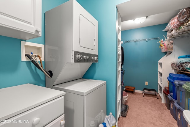 567 Deal Pkwy, Allenhurst, NJ 07711 - laundry area featuring stacked washer and clothes dryer, cabinet space, and light colored carpet