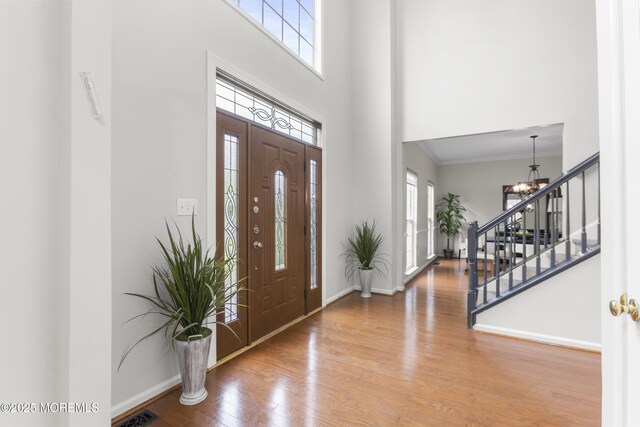 29 Jefferson Ct, Jackson, NJ 08527 - entrance foyer with healthy amount of natural light, stairway, wood finished floors, a chandelier, and a towering ceiling