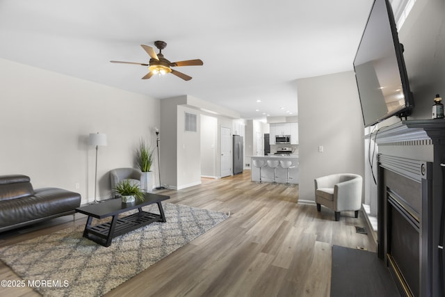 29 Jefferson Ct, Jackson, NJ 08527 - living area featuring light wood finished floors, a ceiling fan, baseboards, a fireplace with flush hearth, and recessed lighting