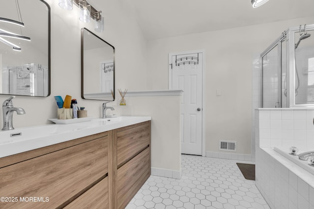 11 Charles Ct, Ocean Twp, NJ 07712 - full bath with double vanity, a shower stall, a garden tub, baseboards, and tile patterned flooring
