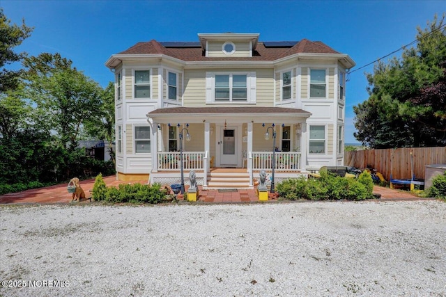 57 Shore Dr, Highlands, NJ 07732 - victorian house with a porch, roof mounted solar panels, and fence