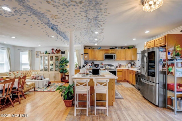 57 Shore Dr, Highlands, NJ 07732 - kitchen featuring appliances with stainless steel finishes, light countertops, recessed lighting, light wood-style flooring, and a breakfast bar area