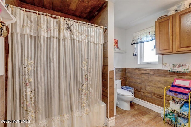 57 Shore Dr, Highlands, NJ 07732 - bathroom featuring toilet, wood finished floors, wainscoting, and a shower with shower curtain