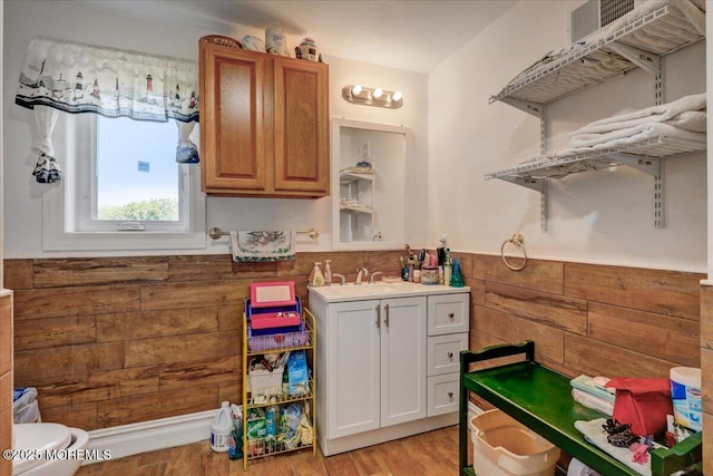 57 Shore Dr, Highlands, NJ 07732 - kitchen with light wood finished floors, a sink, light countertops, wainscoting, and brown cabinetry