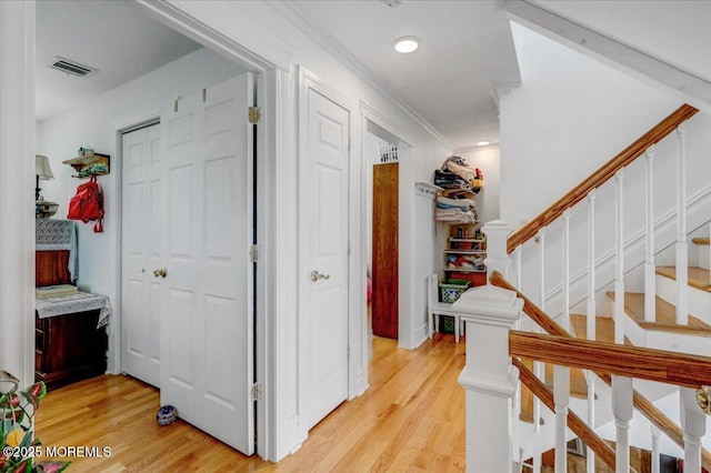 57 Shore Dr, Highlands, NJ 07732 - hallway featuring light wood-type flooring, ornamental molding, and stairs