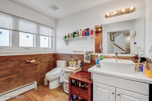 57 Shore Dr, Highlands, NJ 07732 - bathroom with a baseboard radiator, a wainscoted wall, wood finished floors, toilet, and vanity