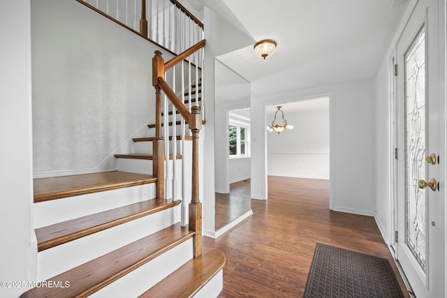 7 Colonial Ct, Manalapan, NJ 07726 - foyer entrance with wood finished floors, stairway, a chandelier, and baseboards