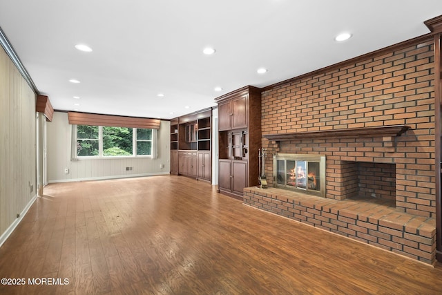 7 Colonial Ct, Manalapan, NJ 07726 - unfurnished living room with a fireplace, wood finished floors, recessed lighting, baseboards, and crown molding