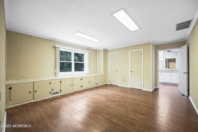 7 Colonial Ct, Manalapan, NJ 07726 - unfurnished bedroom featuring crown molding, dark wood-style floors, multiple closets, and baseboards