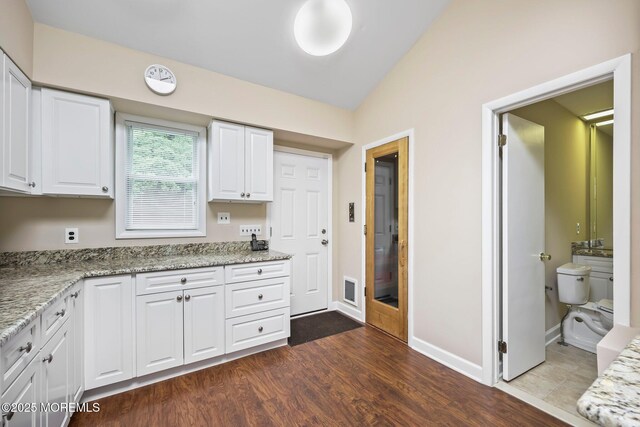 7 Colonial Ct, Manalapan, NJ 07726 - kitchen featuring white cabinetry, vaulted ceiling, dark wood-style floors, light stone countertops, and baseboards