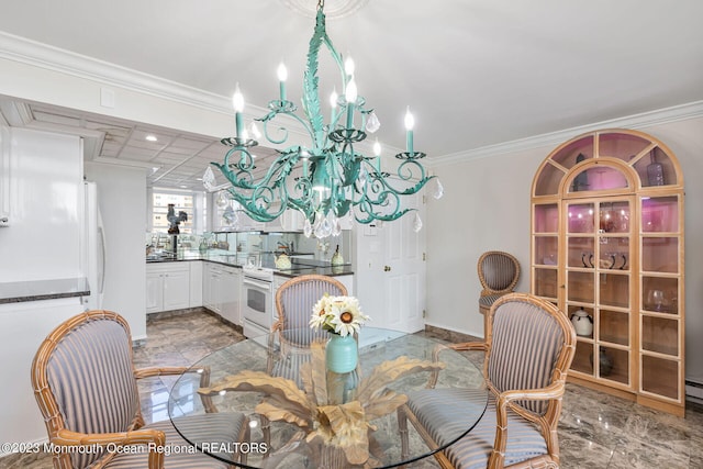 dining space with a chandelier, ornamental molding, and baseboards