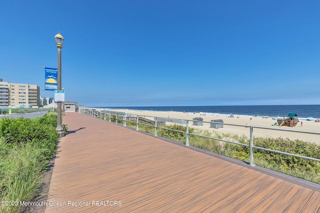 view of property's community with view of water and beach