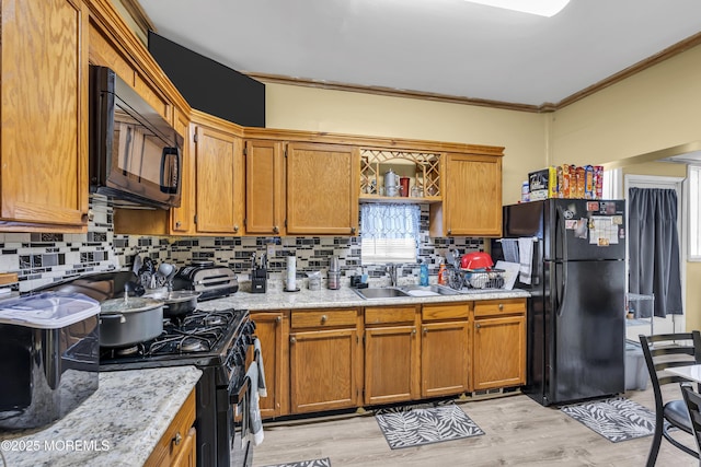 430 Myrtle Ave, Neptune Township, NJ 07753 - kitchen with black appliances, decorative backsplash, brown cabinetry, and ornamental molding