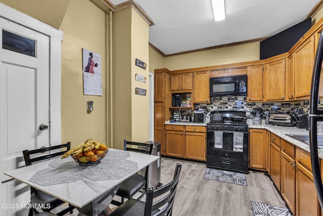 430 Myrtle Ave, Neptune Township, NJ 07753 - kitchen featuring black appliances, decorative backsplash, light countertops, light wood finished floors, and brown cabinetry
