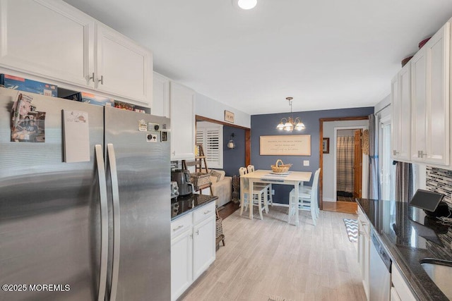 726 Hardean Rd, Brick, NJ 08724 - kitchen featuring appliances with stainless steel finishes, a chandelier, white cabinets, light wood-style flooring, and dark stone countertops