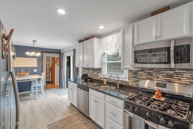 726 Hardean Rd, Brick, NJ 08724 - kitchen featuring appliances with stainless steel finishes, a sink, a chandelier, tasteful backsplash, and white cabinets