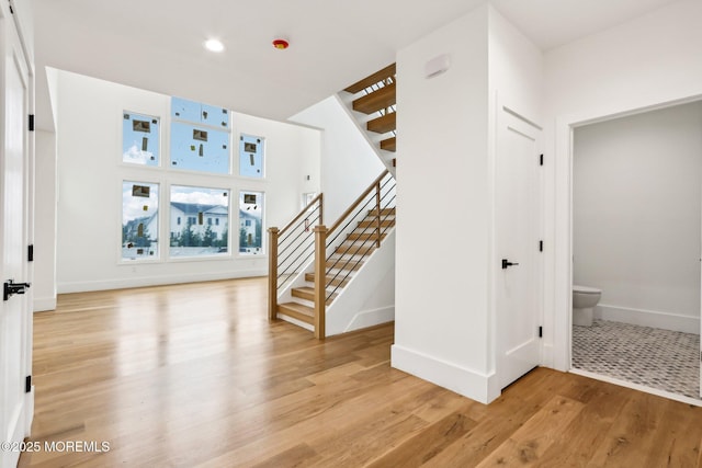 entryway featuring stairs, light wood finished floors, baseboards, and recessed lighting
