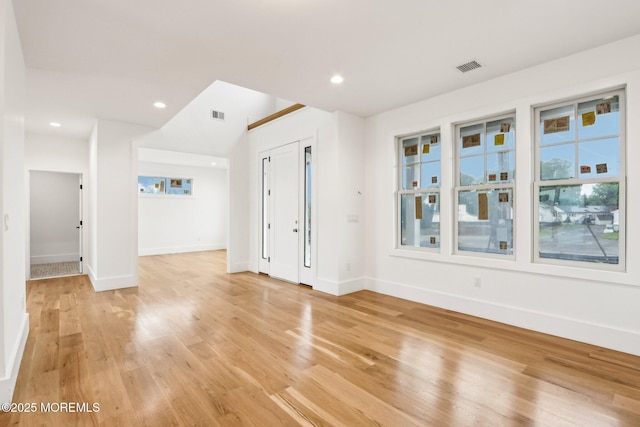 unfurnished living room featuring light wood-style flooring, baseboards, and recessed lighting