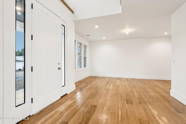 foyer featuring light wood finished floors, baseboards, and recessed lighting