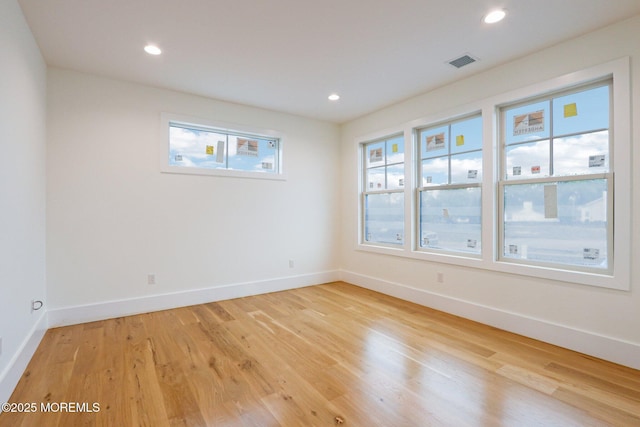 unfurnished room with light wood-style flooring, baseboards, and recessed lighting