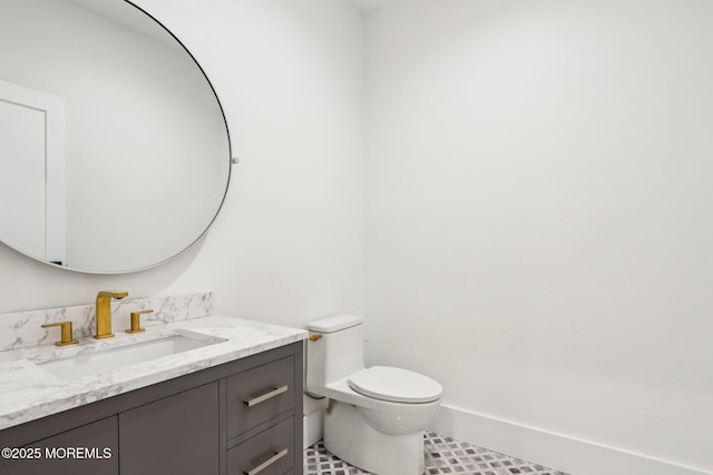 bathroom featuring toilet, vanity, and tile patterned flooring