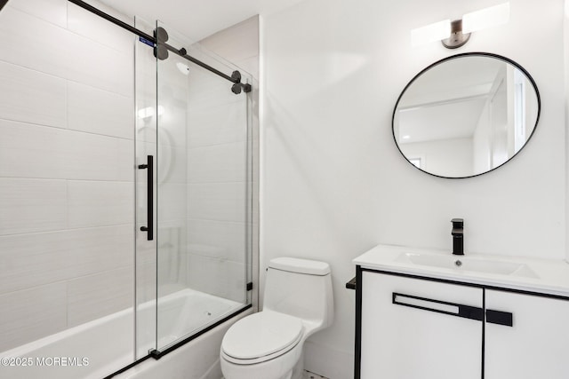 bathroom featuring vanity, toilet, and shower / bath combination with glass door