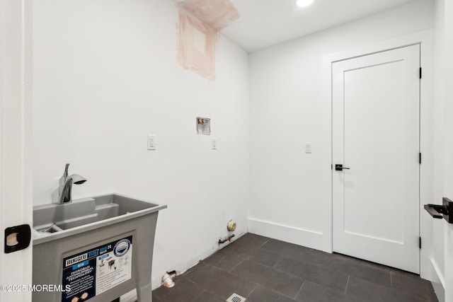 laundry room with washer hookup, gas dryer hookup, and dark tile patterned floors