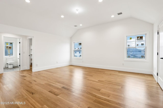 unfurnished living room featuring lofted ceiling, plenty of natural light, light wood-style flooring, recessed lighting, and baseboards
