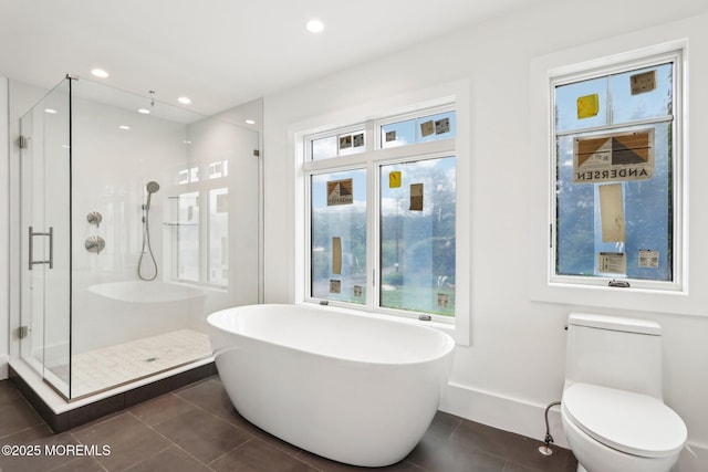 bathroom featuring tile patterned flooring, a stall shower, a soaking tub, toilet, and recessed lighting