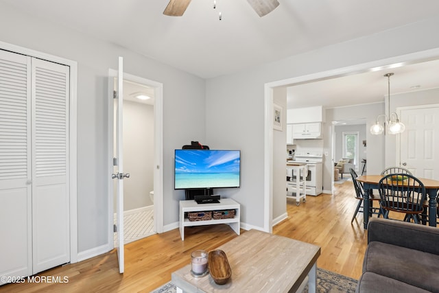 25 Meadow Ave Unit 30, Monmouth Beach, NJ 07750 - living room featuring light wood-style floors, a ceiling fan, and baseboards