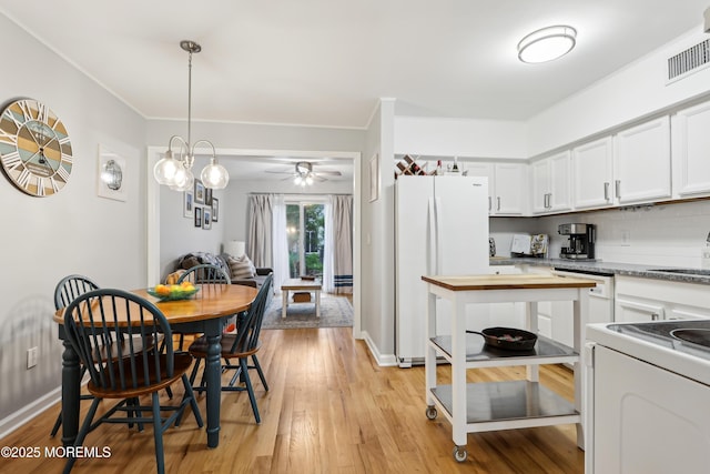 25 Meadow Ave Unit 30, Monmouth Beach, NJ 07750 - dining area with light wood finished floors, a ceiling fan, baseboards, and ornamental molding