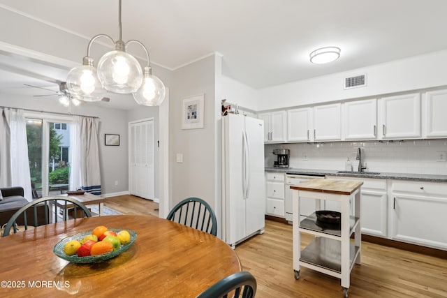 25 Meadow Ave Unit 30, Monmouth Beach, NJ 07750 - dining area featuring light wood-style floors, ceiling fan, and ornamental molding