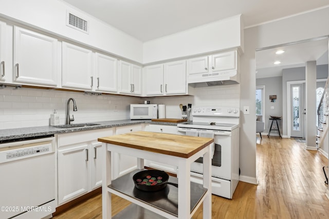 25 Meadow Ave Unit 30, Monmouth Beach, NJ 07750 - kitchen featuring white appliances, under cabinet range hood, a sink, white cabinets, and decorative backsplash