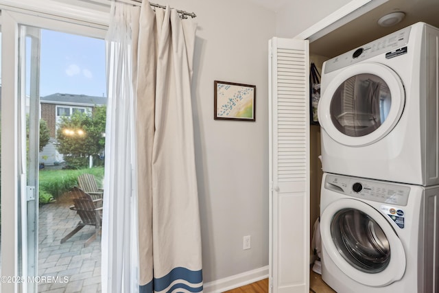 25 Meadow Ave Unit 30, Monmouth Beach, NJ 07750 - laundry area with stacked washer and clothes dryer and baseboards