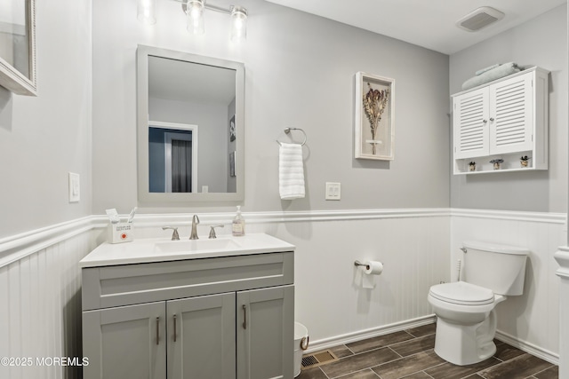 25 Meadow Ave Unit 30, Monmouth Beach, NJ 07750 - bathroom with toilet, a wainscoted wall, wood tiled floors, and vanity