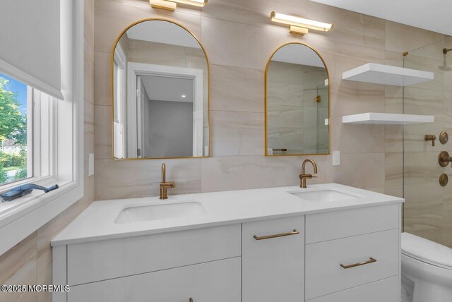 369 Norwood Ave, Long Branch, NJ 07740 - full bath with tile walls, double vanity, a tile shower, toilet, and decorative backsplash