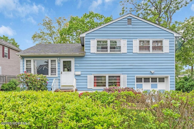 split level home featuring fence and an attached garage