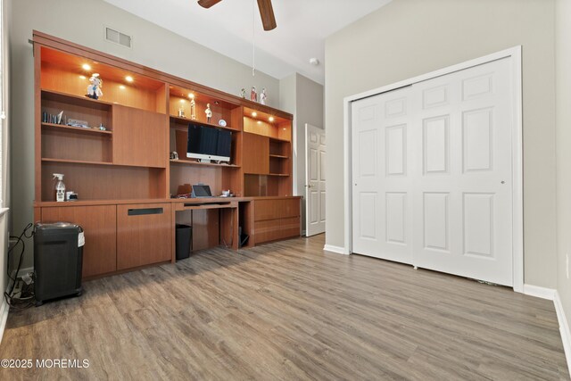6 Beth Page Dr, Monroe, NJ 08831 - home office with light wood-style flooring, a ceiling fan, built in desk, and baseboards
