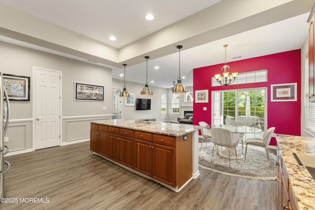 6 Beth Page Dr, Monroe, NJ 08831 - kitchen featuring wood finished floors, brown cabinets, a chandelier, decorative light fixtures, and wainscoting