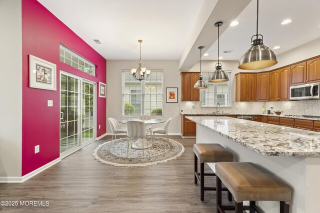 6 Beth Page Dr, Monroe, NJ 08831 - kitchen featuring stainless steel microwave, a chandelier, brown cabinets, gas cooktop, and a sink
