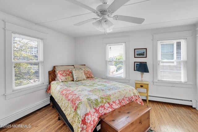 400 W Lake Ave, Bay Head, NJ 08742 - bedroom with light wood finished floors, a baseboard heating unit, a baseboard radiator, and a ceiling fan