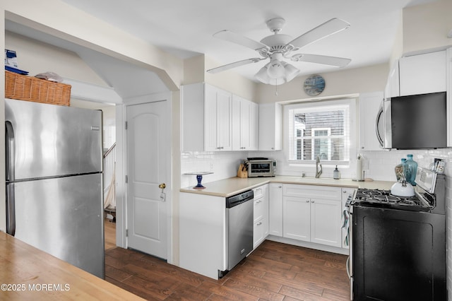 400 W Lake Ave, Bay Head, NJ 08742 - kitchen with stainless steel appliances, a sink, decorative backsplash, a ceiling fan, and light countertops
