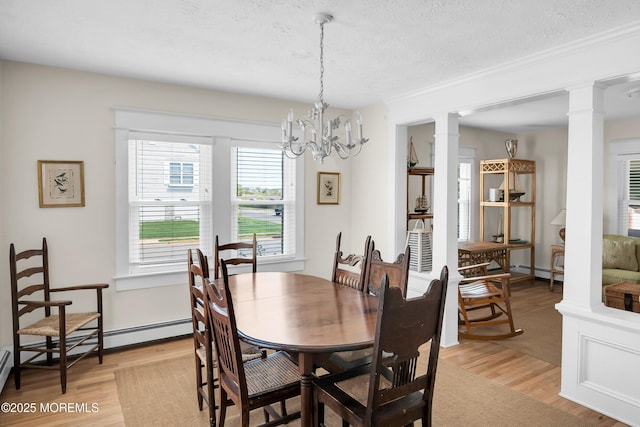 400 W Lake Ave, Bay Head, NJ 08742 - dining area featuring decorative columns, light wood-style floors, a textured ceiling, a chandelier, and a baseboard radiator