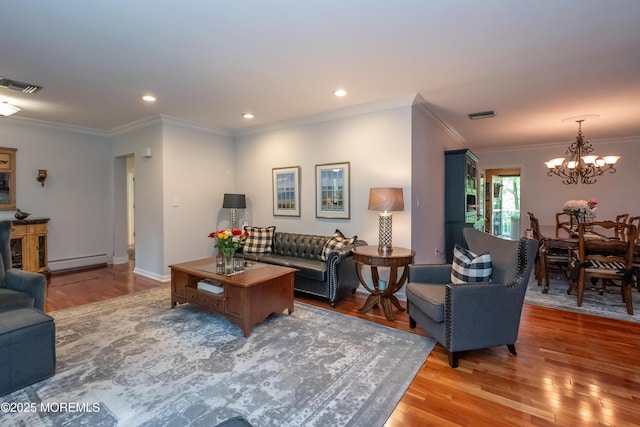 12 Hickory Dr, East Brunswick, NJ 08816 - living room featuring baseboard heating, a chandelier, light wood-style flooring, ornamental molding, and recessed lighting
