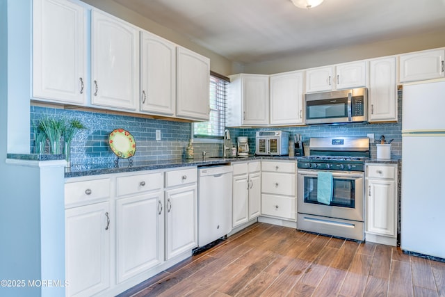 kitchen featuring appliances with stainless steel finishes, a sink, and white cabinets