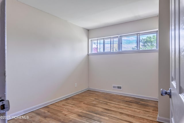 empty room with wood finished floors and baseboards
